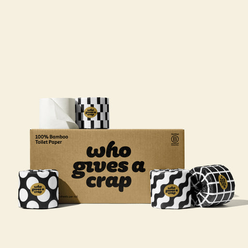 A large box of Who Gives A Crap 100% Bamboo Toilet Paper with black and white wrappers - eco-friendly, biodegradable and sustainable toilet paper 